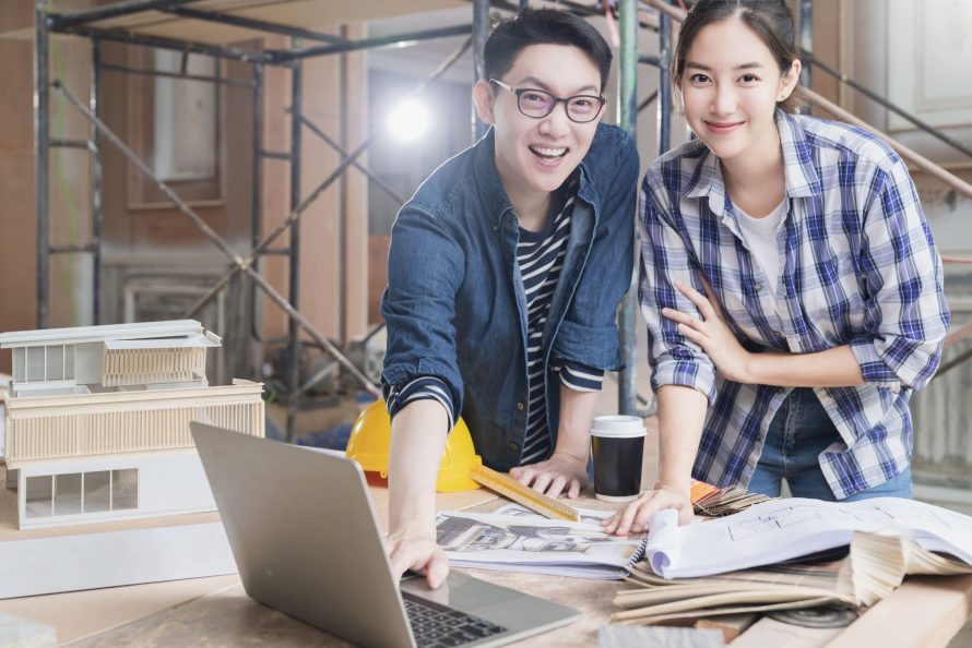 consulting meeting two smart male female asian interior designer achitect with blueprint home mockup material sample with happy house renovate improvement site construction background 1 scaled e1759447329663